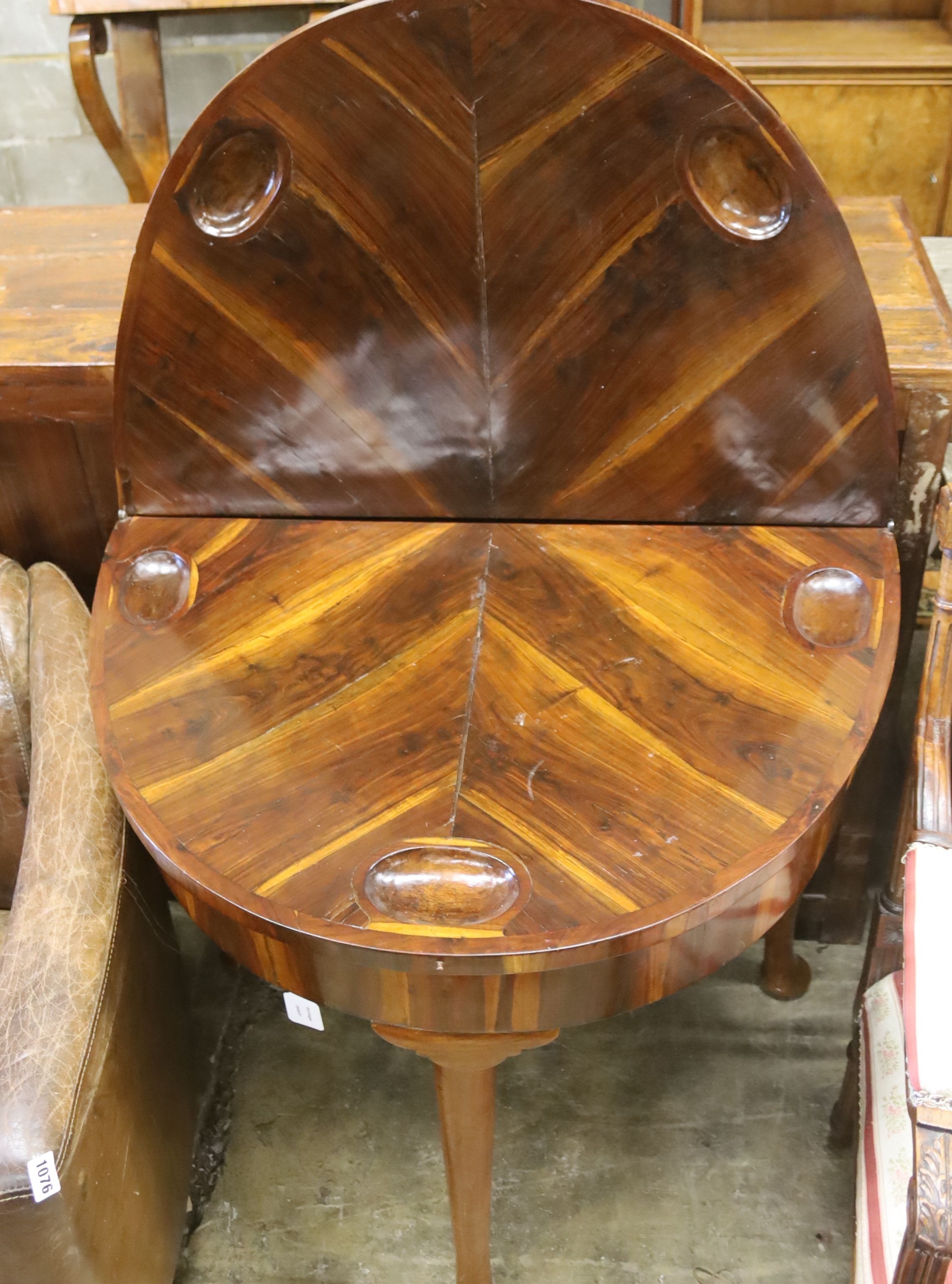 A 18th century Continental Goncalo Alves demi-lune card table with folding top, width 84cm, depth 56cm, height 76cm